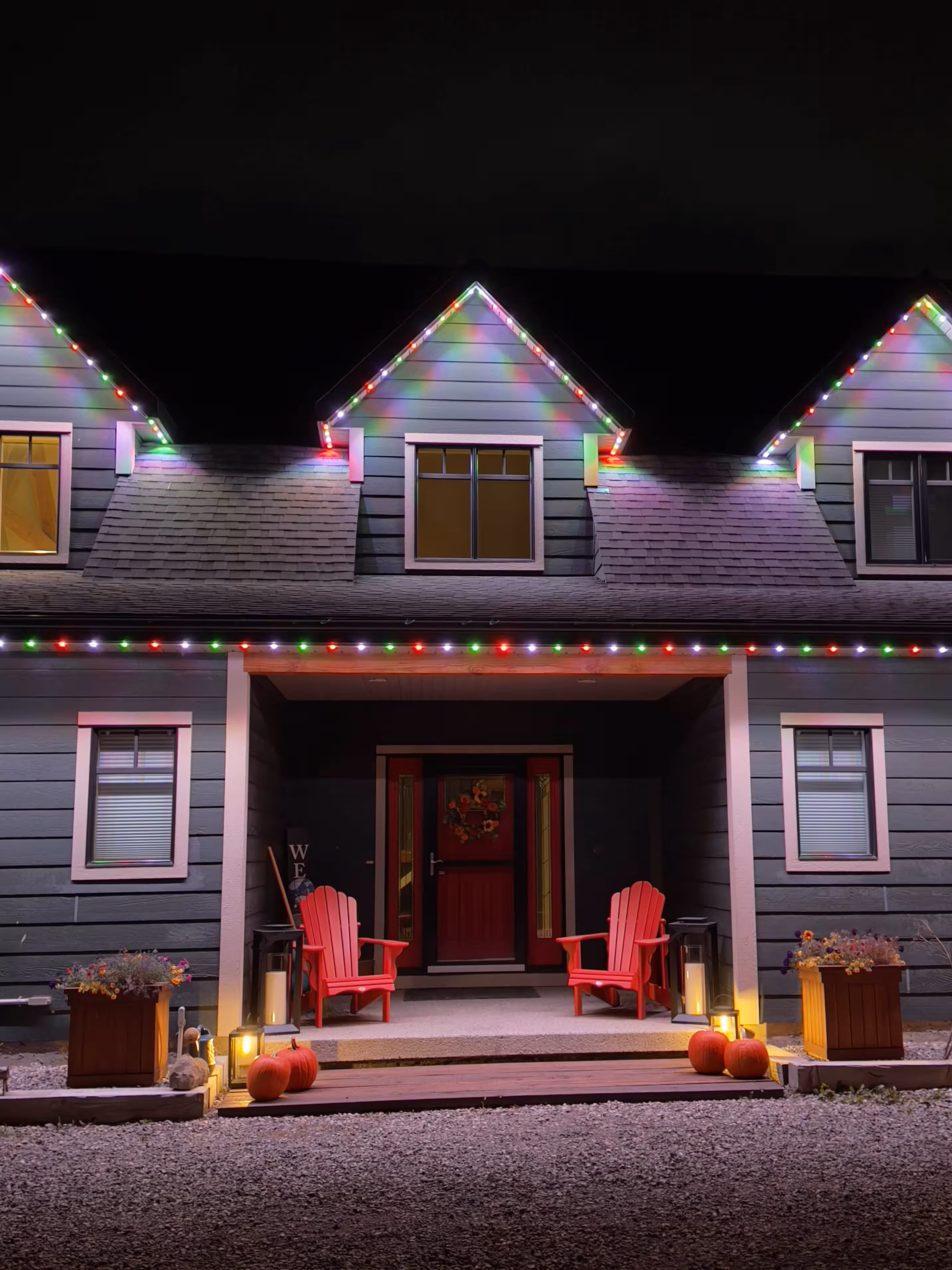 Home with red and green Christmas permanent lighting